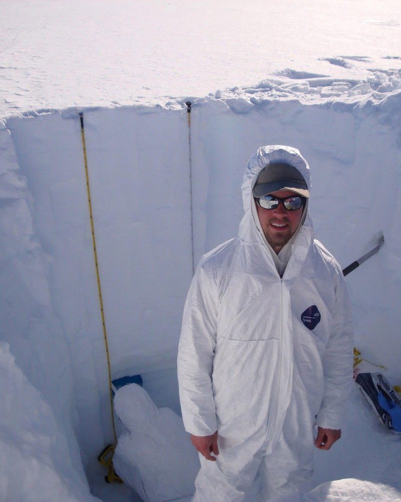 Skylar sampling a snow pit in Antarctica